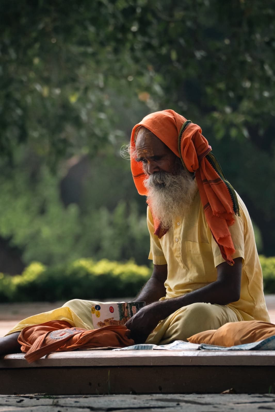 An elder in an orange headscarf